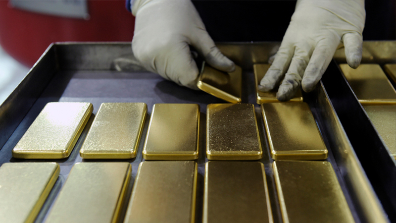 Gold bars being placed in a tray