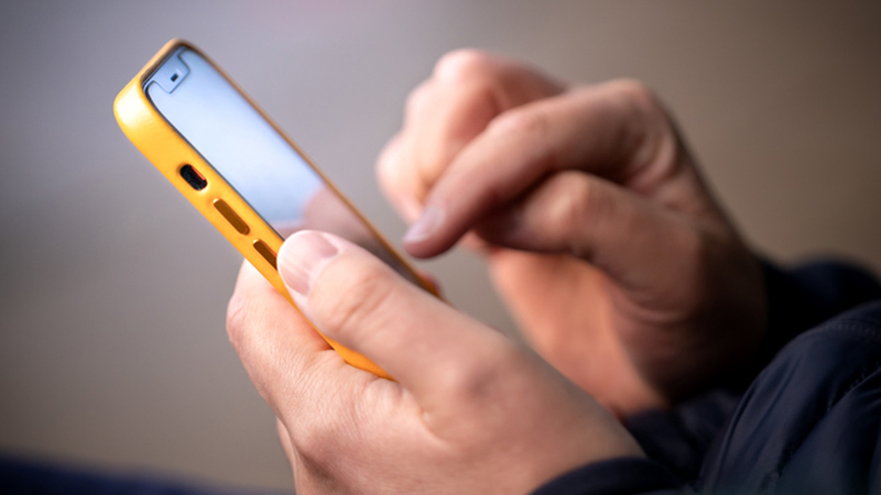 Hands holding mobile phone