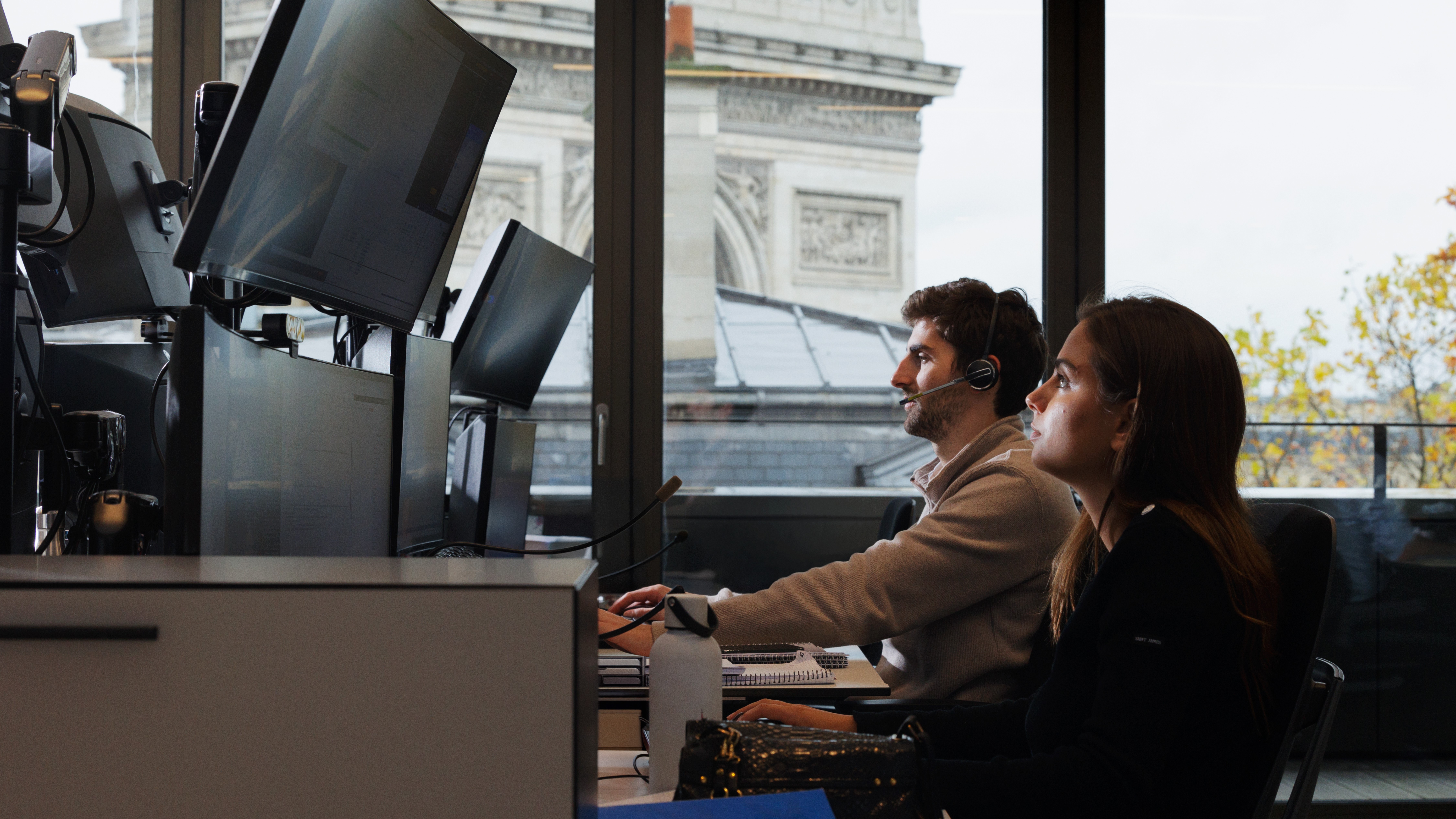 Financial workers in Paris view their computer screens.