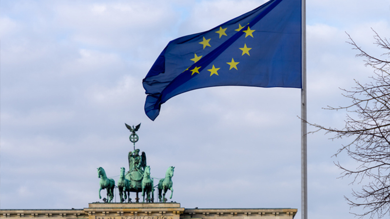 EU flag and the Brandenburg Gate in Berlin