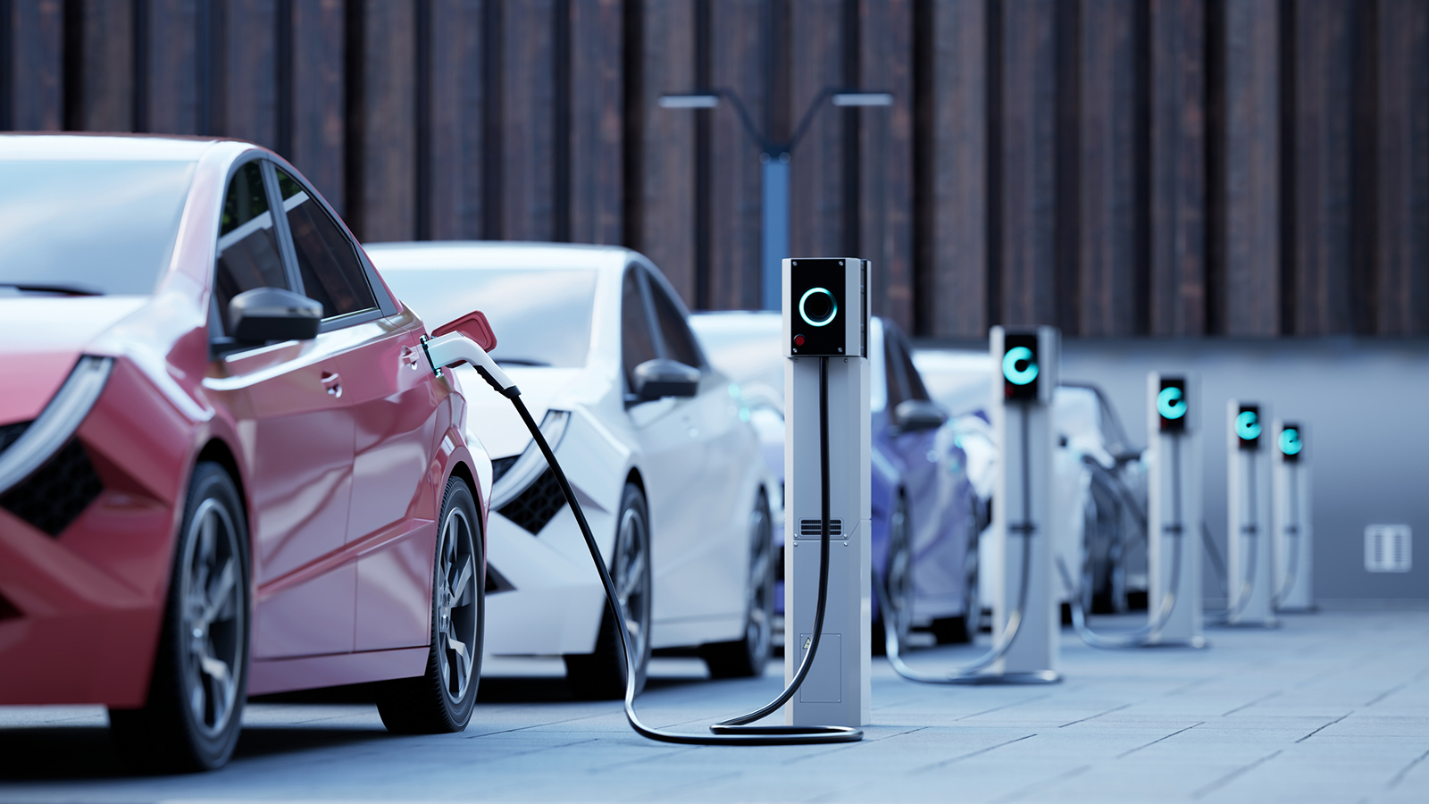 A line of electric self-driving cars at charging stations.