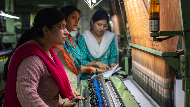 Women work at a textile factory in India
