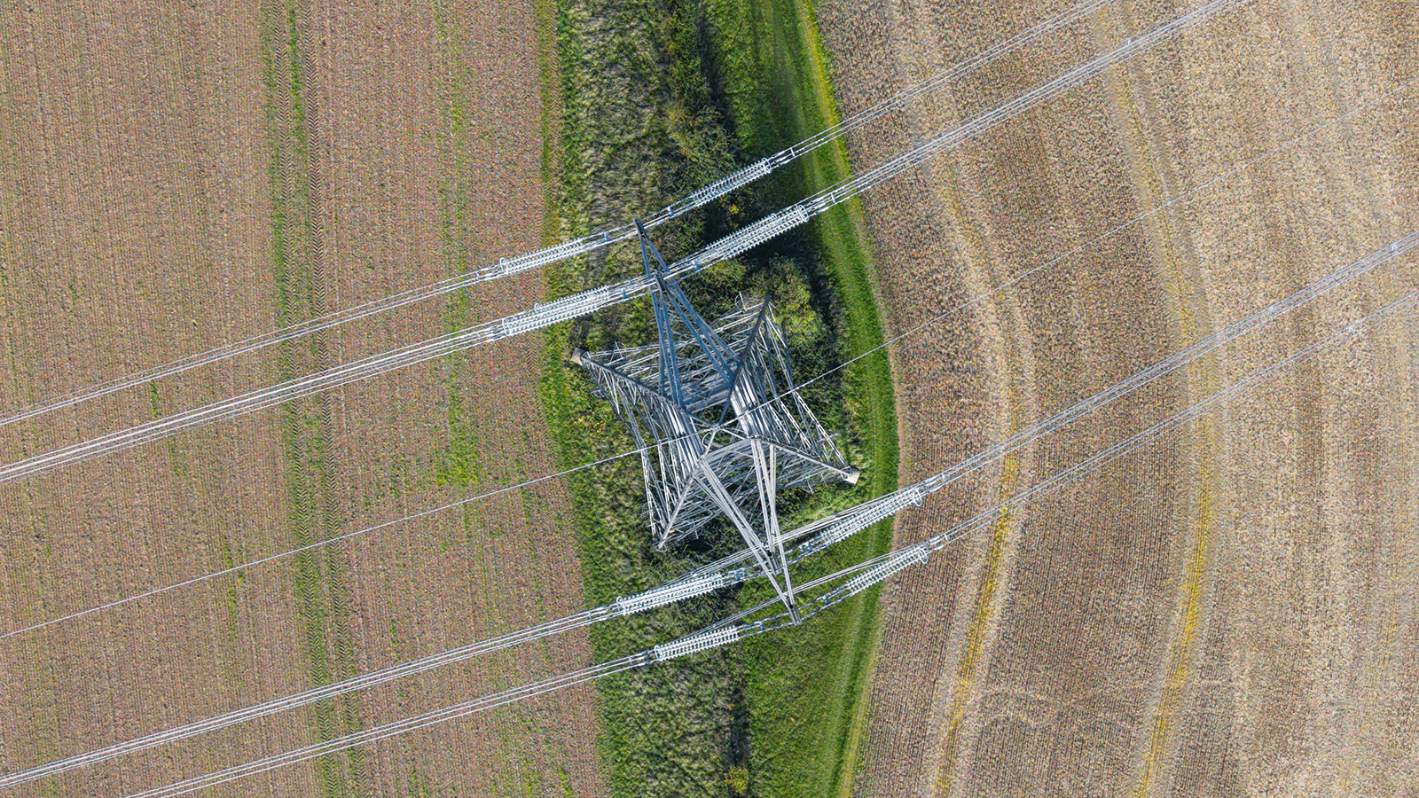 Overhead photo of electrical pylons in a field