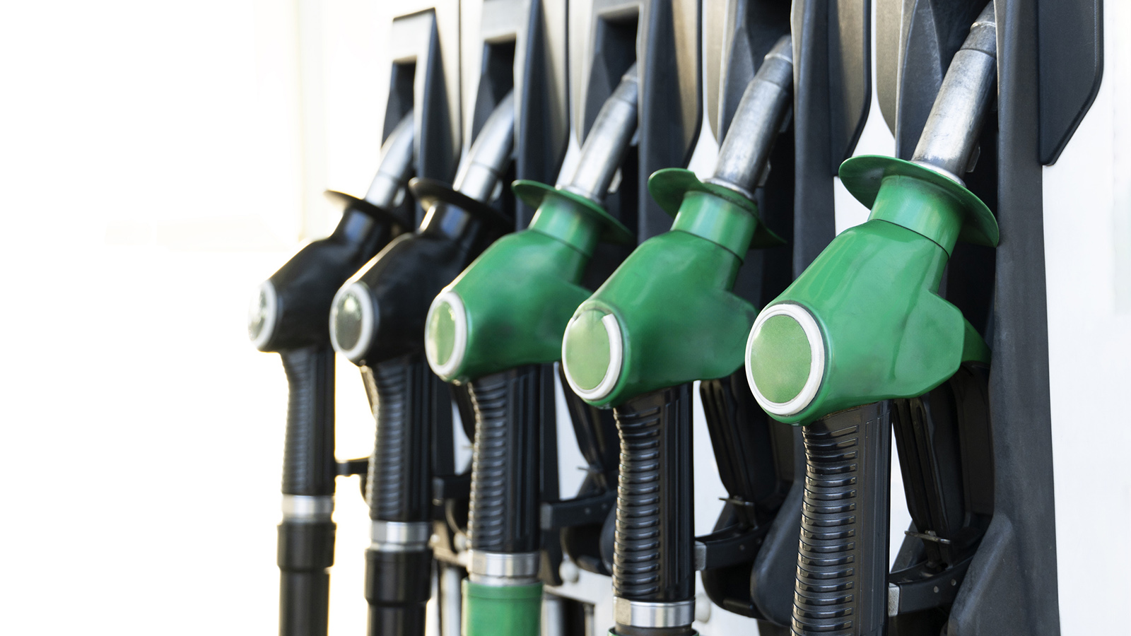 A row of gasoline nozzles at a fuel station.