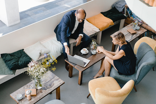 Two people mid-conversation at a cafe table